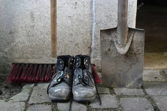 Hausmeister mit Werkzeugkoffer vor einem Mehrfamilienhaus